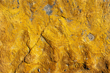 Vibrant yellow sulfur rocks with textured surface