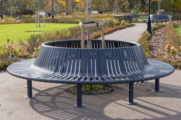 Modern round metal park bench for relaxing in the park