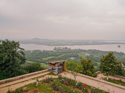 SRINAGAR KASHMIR - CIRCA - Unidentified people relax in the grounds of the Pari Mahal, a Mughal terraced garden palace on the banks of Dal Lake.