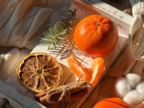 Cozy scene with fresh mandarins and warm knit textures