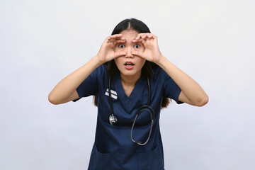 Young asian doctor woman over isolated background.Trying to open eyes with fingers, sleepy and tired for morning fatigue