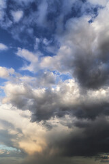 Fototapeta premium Storm cloudy dramatic sky with dark rainy grey gray and white cumulus clouds against blue sky background texture, thunderstorm, heaven