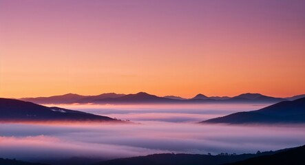Obraz premium Sunrise over misty mountains warm hues and morning fog