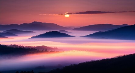 Obraz premium Sunrise over misty mountains warm hues and morning fog