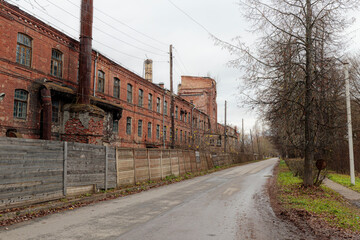 Abandoned, crumbling red brick factory building in Krasnofarforny, Leningrad region, Russia, under...