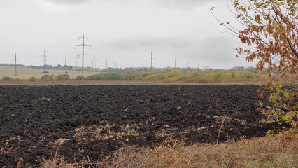 A plowed field on a cloudy day