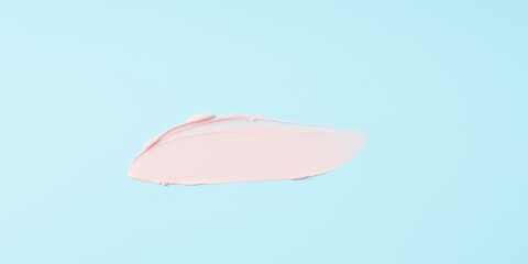 Fototapeta premium A single stroke of pink paint on a light blue background, a simple and abstract image that represents a creative expression