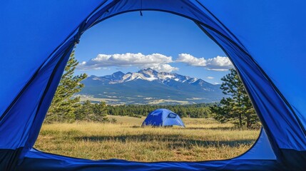 A tent opening reveals a panoramic view of snow-capped mountains with a deep blue sky and clouds drifting lazily over the peaks.