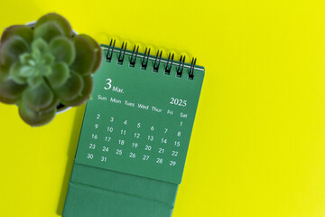 March 2025. Desk calendar for planning tasks on a yellow background.