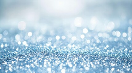 Fototapeta premium Shimmering light blue bokeh with sparkling glitter, perfect for Christmas or New Year themed backgrounds