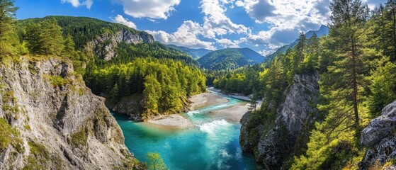 A scenic river winding through lush green mountains under a bright blue sky.