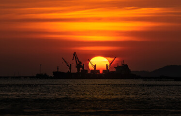 Large cargo ship against sunset