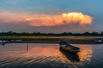 Small boat in the evening reservoir