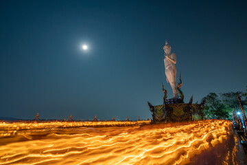 White Buddha with many candles