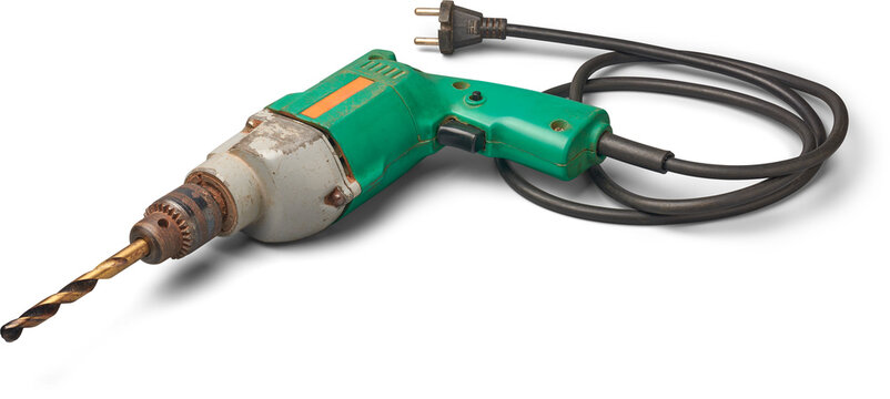 old used metal electric drill with its black wire isolated white background, corded tool with simple design 