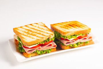 Club sandwich with ham, cheese, tomato and lettuce. 