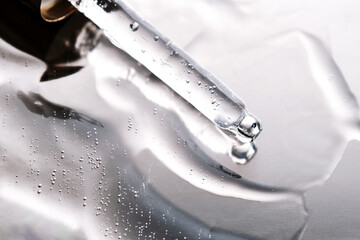 Dropper pipette with delicious serum with bubbles on the gel texture.
