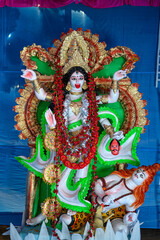 Idol of Goddess Maa Kali at a decorated puja pandal in West Bengal, India, during Kali puja, a...