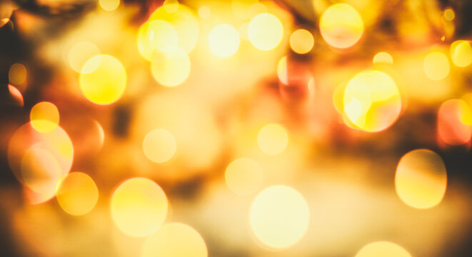 blurred bokeh of Christmas lights. Magic holiday abstract glitter background with blinking stars and falling snowflakes.