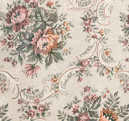 Seamless old-fashioned floral pattern on a tapestry fabric texture biege background. Old retro fashion style