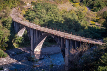 Fototapeta premium A bridge over a mountain river with high banks