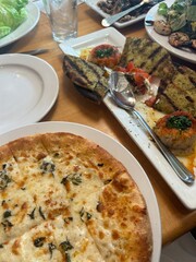 pizza on a plate with Mediterranean food