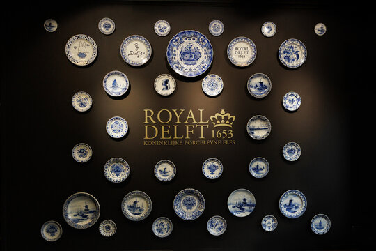 Delft, Netherlands - July 7, 2024: Pottery masterpieces in blue and white handmade painting porcelain at the Royal Delft museum entrance hall