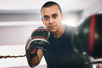 Boxing ring, hit and portrait of man in gym with confidence, power or fitness challenge in sports...