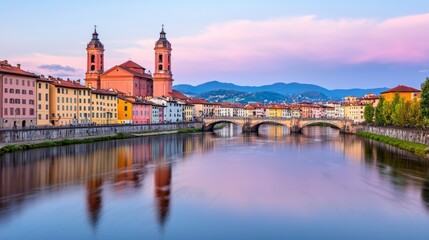 A view of a river with a bridge and colorful buildings in the background, with a dramatic sky.