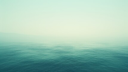 Obraz premium A serene ocean view in soft pastels, showcasing calm waters and a hazy horizon.