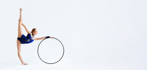 Professional sport. Graceful woman doing gymnastics with hoop on white background, blank space © Prostock-studio