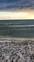 Obraz premium Sea, beach and pebbles, clouds in the sea. 