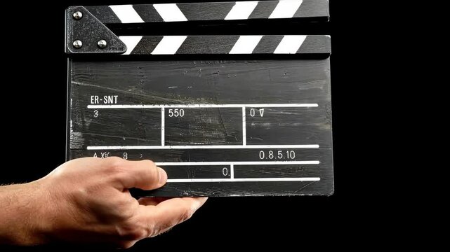 Clapperboard in use for a film production during sunset in a studio setting