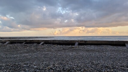 Obraz premium Sea, beach and pebbles, clouds in the sea. 