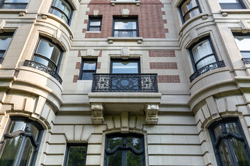 Historic urban residential building with ornate balcony and bay windows in Boston, Massachusetts, USA