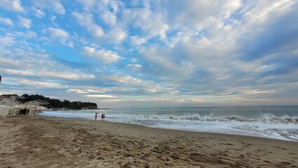 Sea, beach and pebbles, clouds in the sea.

