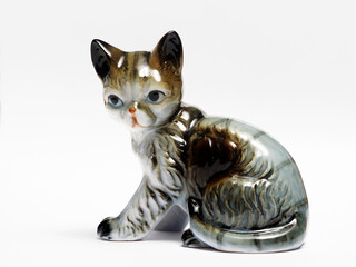 In tis photoillustration Vintage porcelain figurine of cat on white background