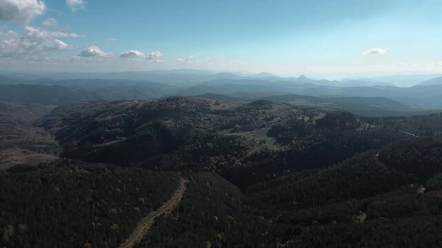 Beautiful view of autumn mix forest and mountain peaks. Nature of western Serbia in early autumn. Aerial view from a drone. Tornik Mountain resort. Horizontal panoramic 4k footage