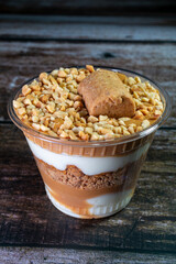 Homemade pot cakes on wooden table with peanut filling and cream.