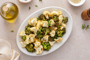Roasted broccoli and cauliflower on a serving plate with herbs and spices