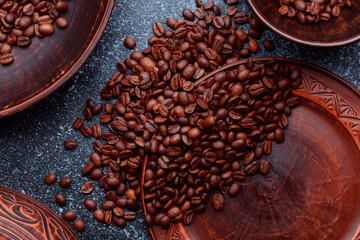Roasted coffee beans in bowl. Rusty background for coffee shop menu. Top view and copy space.