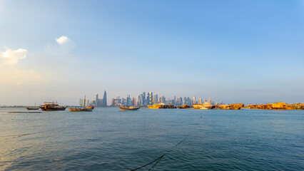 Fototapeta premium Dhow Cruise during sunset time at Dhow harbour background skyscrapers.