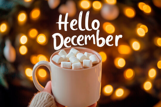 Hello December text with a cozy mug of hot chocolate topped with marshmallows, against a warm background of glowing bokeh lights