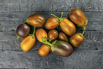 Raw Brown Eggplants on Rustic Wooden Surface Showcasing Rustic Charm and Natural Texture