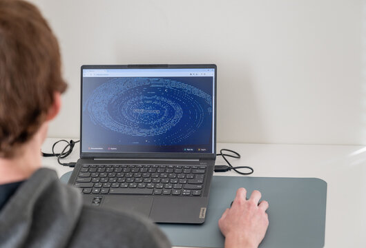 Espoo, Finland - October 29, 2024: Man using the Midjourney on her laptop at home. Midjourney is an artificial intelligence that creates images from textual descriptions