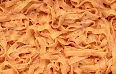Macro photography of tagliatelle with cheese burrata and roasted tomatoes sauce; garlic; herb;...
