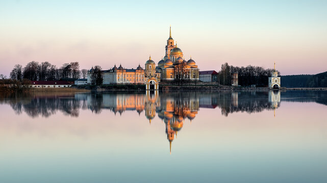 a soft pink dawn and a view of the Nilo-Stolobensky monastery