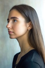 Fototapeta premium Profile of a young woman with long hair and minimalist style