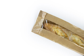 Freshly baked French baguette in a brown paper bag isolated on a white background.Loaf of white bread  wrapped in eco-friendly sustainable brown paper bag. Copy space. With clipping path...