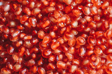 raw delicious red pomegranate seeds covering surface, healthy fruits rich with vitamins, texture, background